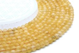 Pomarańczowe koraliki kalcytu o średnicy 6 mm na nitce 40 cm